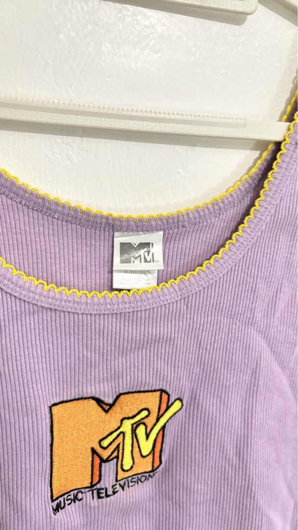 MTV Graphic Ribbed Crop Tank Top (Category: Sleeveless) located in Caloocan City. Submitted by buymethisandthat (Listing ID 1460029128, Image 2). Description: ✨ MTV Graphic Ribbed Crop Tank Top with Yellow Trim - ₱149 📌 CONDITION • Condition: 9/10 • Flaws: None visible 📏 SIZE • Tag Size: XL • Recommended: Fits Medium to Large as a crop top .