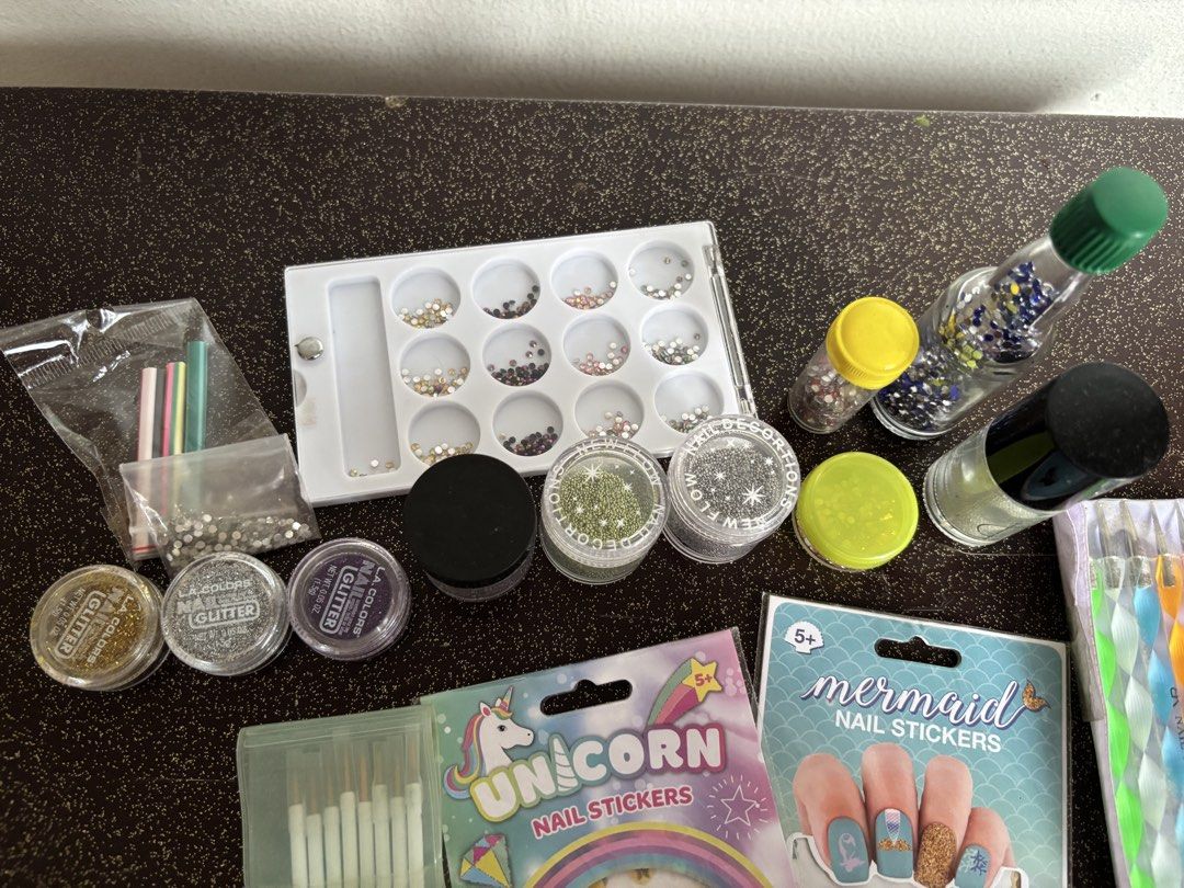 Nail Art Set (Category: Hands & Nails) located in Mandaluyong City. Submitted by caught.on.closet (Listing ID 1459981635, Image 3). Description: Nail art bundle Inclusions: - nail stickers (unicorn, mermaid, emoji) - dotting tools (5) - nail art brushes (8) - nail glitter (gold, silver, purple) - nail gems (blue, pink, red, assorted set) - nail caviar beads (green, rainbow, silver, clear) - nail appliqués (cupcake, popsicle, watermelon) TAKE ALL 