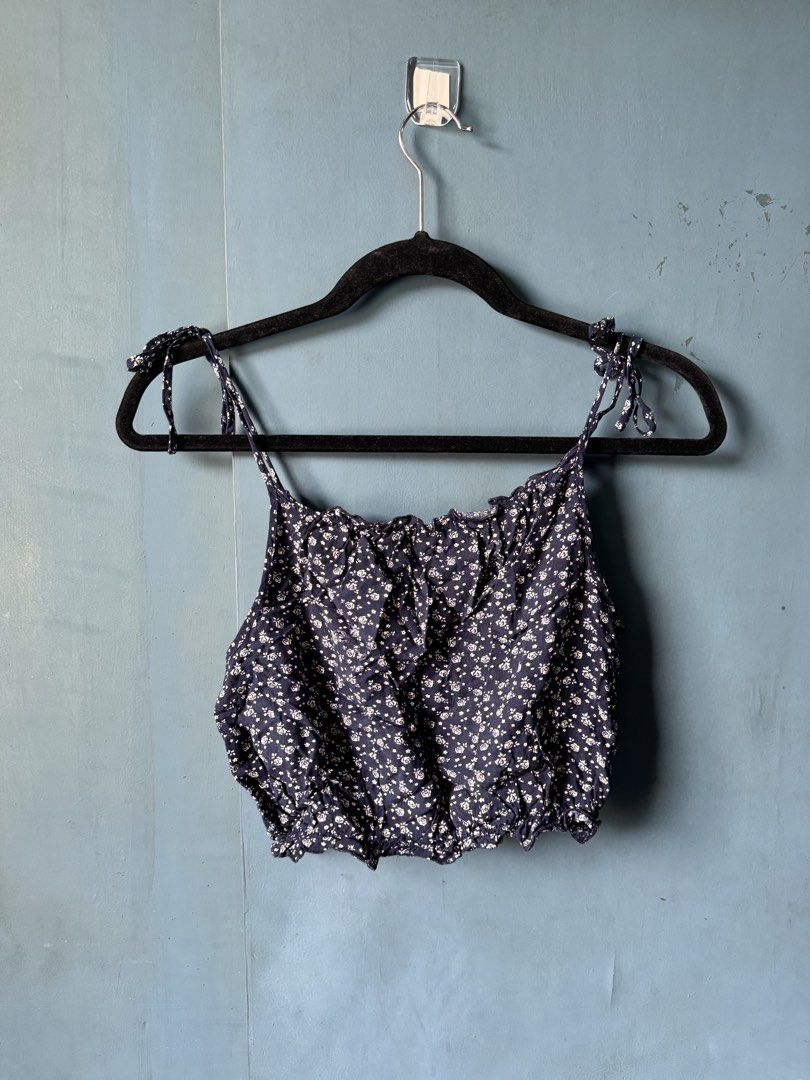 Navy Floral Tie Strap Crop Top (Category: Sleeveless) located in Manila. Submitted by reesespiecess (Listing ID 1460076995, Image 2). Description: - Navy blue crop top - White floral print - Ruffled neckline - Ruffled hem - Tie shoulder straps - Ideal for casual outfits with high-waisted jeans or shorts bought this in brandy singapore! this is an older style item which is more rare these days :).
