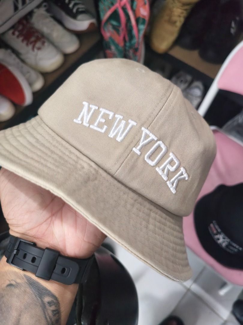 New York Yankees & LA Dodgers Caps Bundle (Category: Caps & Hats) located in Santa Rosa. Submitted by izxenjairr80094 (Listing ID 1459921542, Image 1). Description: - Bundle includes two caps: a tan 'NEW YORK' bucket hat and a green 'LA' baseball cap. - Tan bucket hat features 'NEW YORK' embroidery, 'NY' logo, and MLB logo. - Green baseball cap has an 'LA' logo. - Great for any fan of New York or Los Angeles teams!.