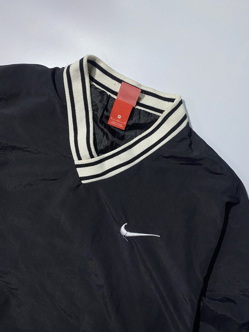 Nike Black Pullover V-Neck Jacket with Swoosh Logo (Category: Coats, Jackets and Outerwear) located in Caloocan City. Submitted by retrowear.gallery (Listing ID 1460026838, Image 2). Description: - Black Nike pullover jacket - V-neck collar with white stripes - White Nike swoosh on chest - Large white swoosh graphic on back - Elasticated cuffs and hem - Ideal for casual wear or sports.