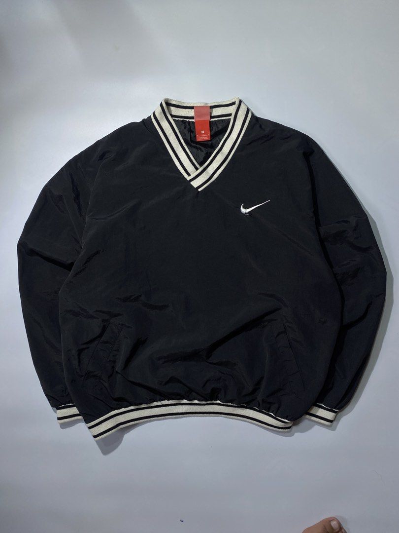 Nike Black Pullover V-Neck Jacket with Swoosh Logo (Category: Coats, Jackets and Outerwear) located in Caloocan City. Submitted by retrowear.gallery (Listing ID 1460026838, Image 1). Description: - Black Nike pullover jacket - V-neck collar with white stripes - White Nike swoosh on chest - Large white swoosh graphic on back - Elasticated cuffs and hem - Ideal for casual wear or sports.