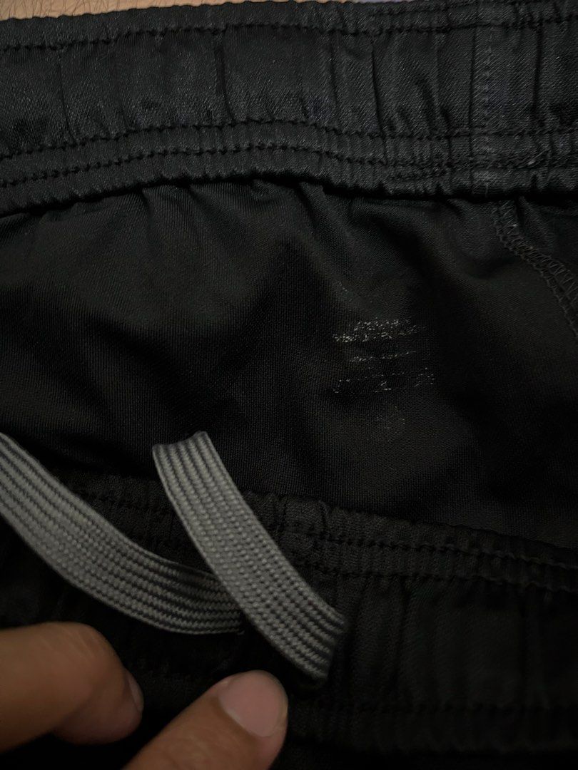 Nike Drifit Black Track Pants with Grey Stripes (Category: Joggers) located in Pasay City. Submitted by Oboyyy (Listing ID 1459793244, Image 3). Description: - Black Nike track pants - Iconic embroidered Nike swoosh logo on left leg - Two grey stripes down the sides of each leg - Comfortable elastic waistband - Ideal for sports or casual wear.