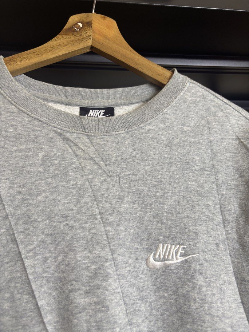 Nike Grey Crewneck Sweatshirt Size L (Category: Coats, Jackets and Outerwear) located in San Jose. Submitted by galitsabarat (Listing ID 1459962686, Image 3). Description: EXCELLENT CONDITION FRESH FROM BALE NEED WASH LARGE ON TAG 22x30.5 - Classic grey Nike crewneck sweatshirt - Simple and timeless design - Features a small embroidered Nike logo on the chest - Made in Pakistan - Tagged size L - Ideal for casual and everyday wear.