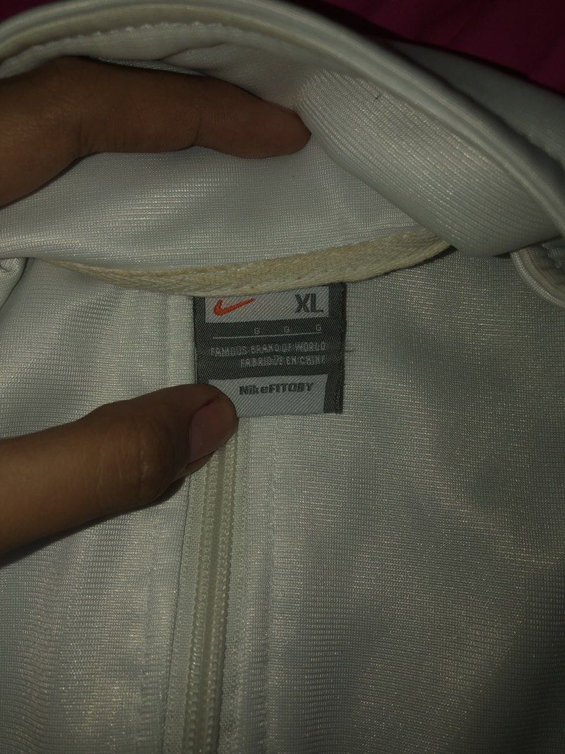 Nike Windbreaker Jacket Pink White XL (Category: Coats, Jackets and Outerwear) located in Bulacan. Submitted by shinzyx (Listing ID 1460020612, Image 3). Description: - Nike Windbreaker Jacket - Size: XL - Color: White with pink upper section - Features Nike logo on the chest - Ribbed cuffs and hem with red stripe details - Full zip front closure - Perfect for casual wear.