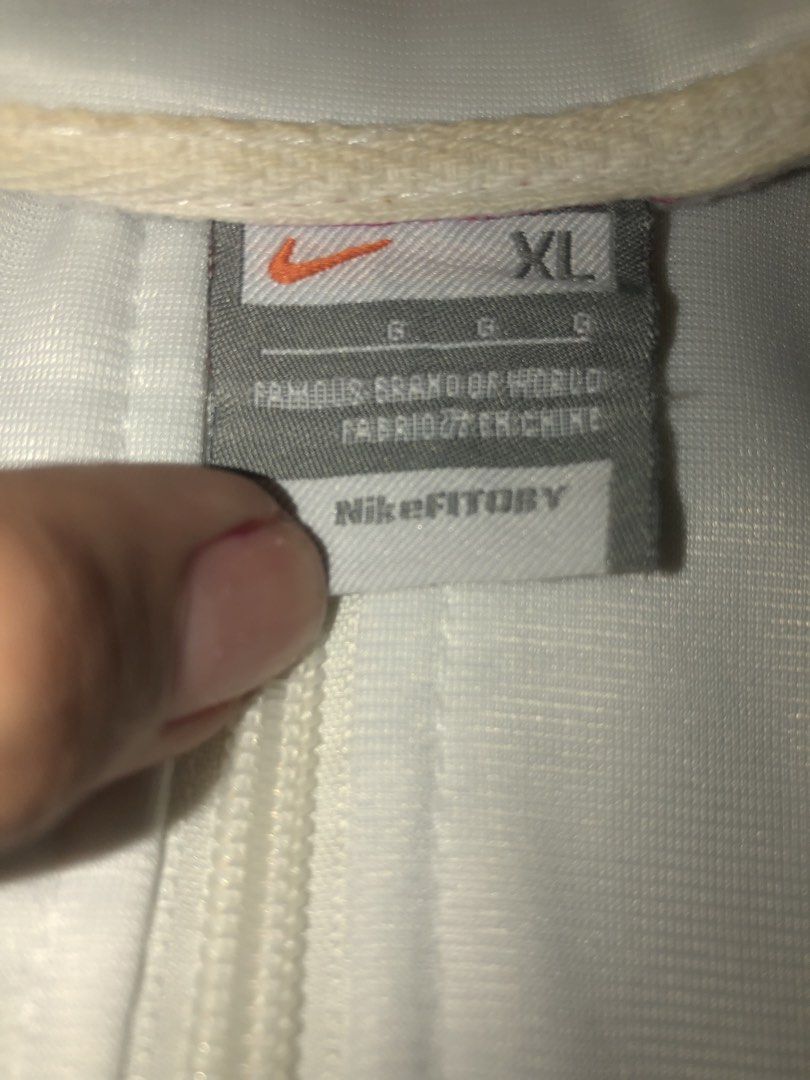 Nike Windbreaker Jacket Pink White XL (Category: Coats, Jackets and Outerwear) located in Bulacan. Submitted by shinzyx (Listing ID 1460020612, Image 2). Description: - Nike Windbreaker Jacket - Size: XL - Color: White with pink upper section - Features Nike logo on the chest - Ribbed cuffs and hem with red stripe details - Full zip front closure - Perfect for casual wear.