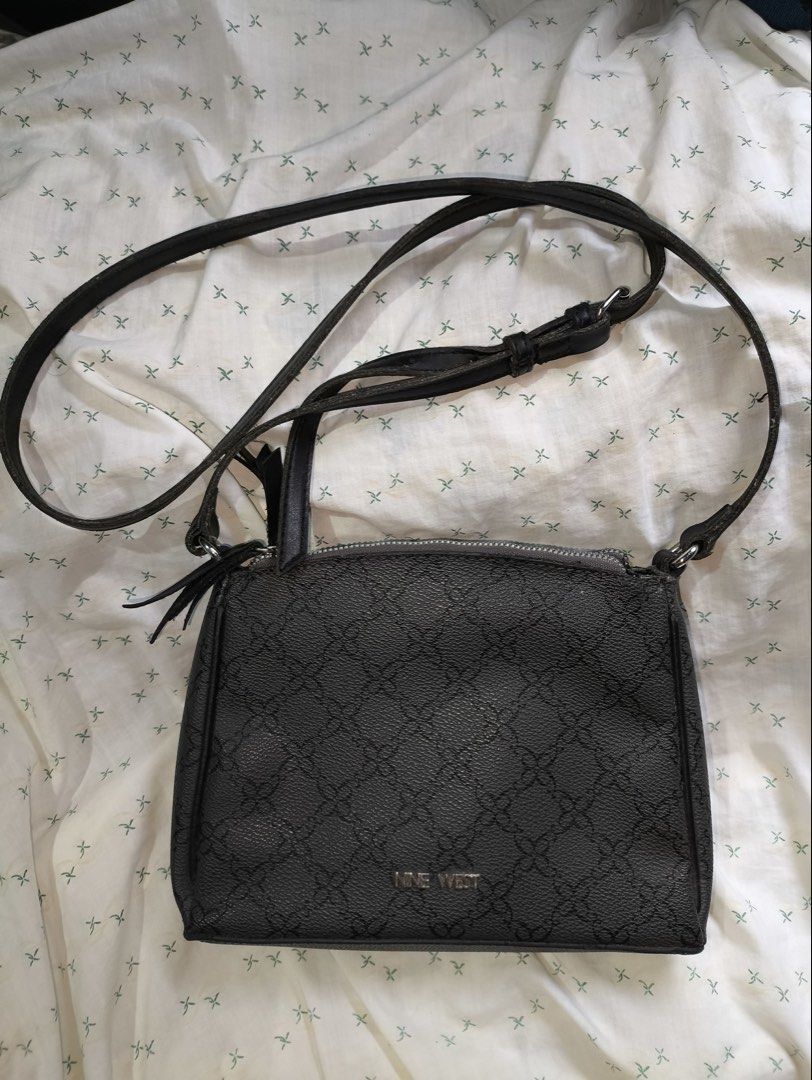 Nine West Black Monogram Crossbody Bag (Category: Cross-body Bags) located in Quezon City. Submitted by titapple (Listing ID 1460051883, Image 1). Description: - Black Nine West crossbody bag - All-over monogram pattern - Secure zipper closure - Adjustable strap for comfort - Stylish tassel detail on zipper pull - Ideal for everyday use - Fits all your essentials.