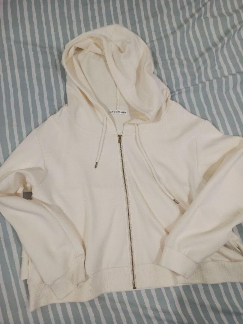 Nostalgia Cream Zip-Up Hoodie (Category: Coats, Jackets and Outerwear) located in Pasig City. Submitted by vvneehoonie (Listing ID 1460079154, Image 1). Description: - Cream colored zip-up hoodie from Nostalgia - Features a drawstring hood - Ribbed cuffs and hem for a snug fit - Super comfy and casual design - Ideal for layering or wearing solo - Effortlessly pairs with any outfit.