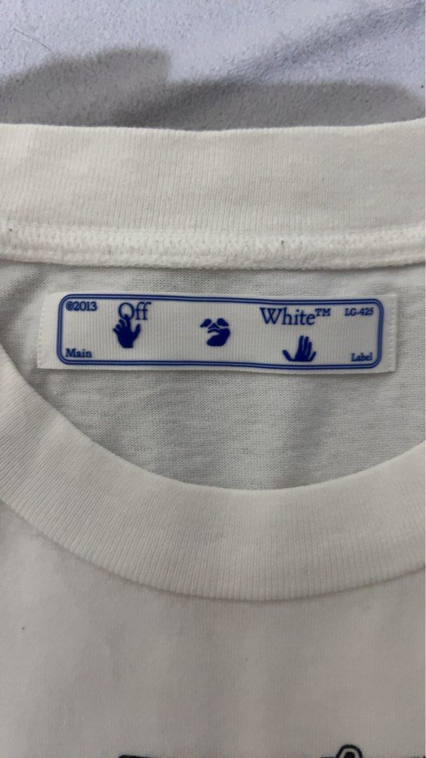 Off-White White Arrows Graphic T-Shirt (Category: Tshirts & Polo Shirts ) located in Cotabato. Submitted by zhypedends136 (Listing ID 1460026365, Image 3). Description: - Authentic Off-White t-shirt - Color: White - Front graphic: Blue - Back graphic: Iconic Off-White arrows - Includes authenticity tag - Perfect for streetwear enthusiasts.