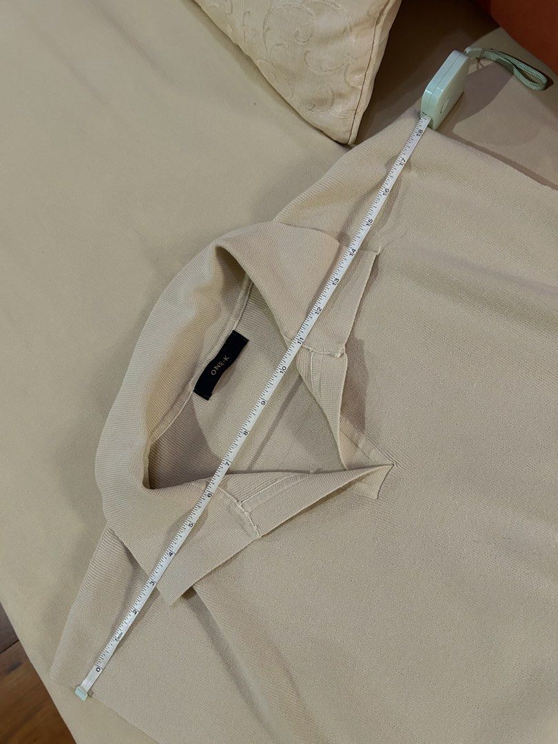 ONE-K Beige Sleeveless Collared Knit Top (Category: Sleeveless) located in Cainta. Submitted by unboxingstuff (Listing ID 1459970260, Image 3). Description: - Beige knit sleeveless top - Brand: ONE-K - Features a collar and V-neckline - Ribbed hem detail - Versatile: great for layering or wearing on its own - Made from super comfy knit material - Bought in Thailand.
