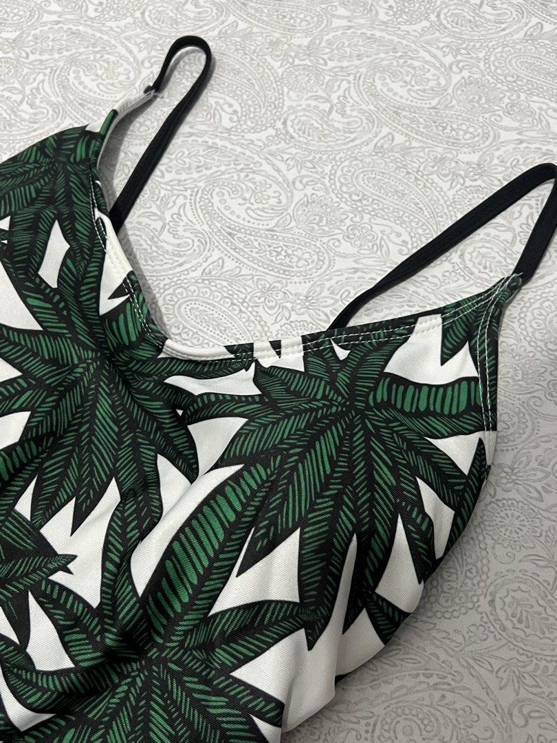 One-piece swimsuit with green leaf print (Category: Bikinis & Swimsuits) located in Manila. Submitted by justppatterns (Listing ID 1459913020, Image 2). Description: - Stylish one-piece swimsuit - Eye-catching green leaf print on a white background - Features thin black straps - Designed for a comfortable fit - Ideal for beach, pool, or your next vacation!.