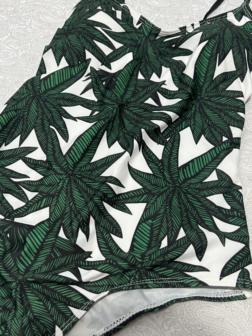 One-piece swimsuit with green leaf print (Category: Bikinis & Swimsuits) located in Manila. Submitted by justppatterns (Listing ID 1459913020, Image 3). Description: - Stylish one-piece swimsuit - Eye-catching green leaf print on a white background - Features thin black straps - Designed for a comfortable fit - Ideal for beach, pool, or your next vacation!.