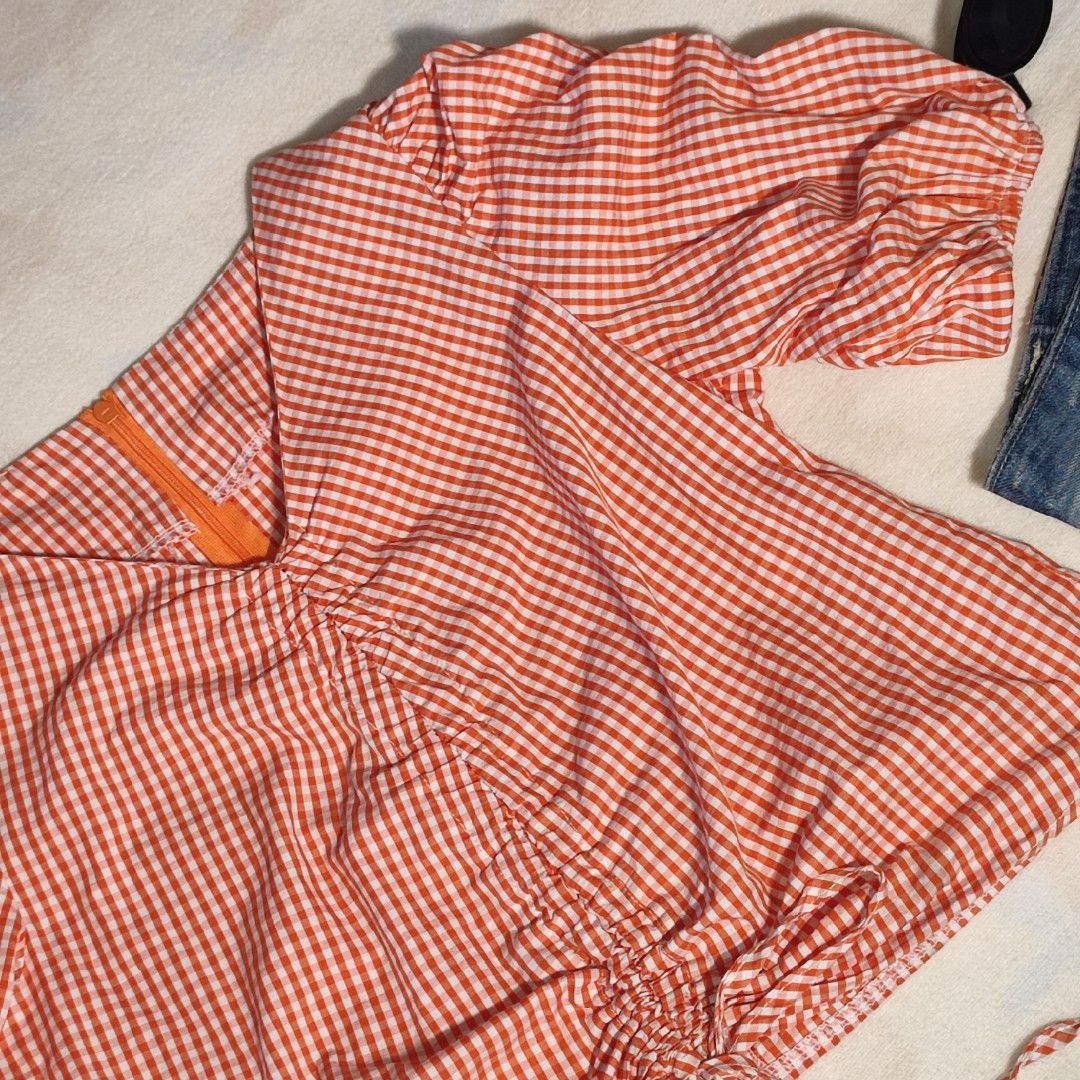 Orange Gingham Ruched Puff Sleeve Top (Category: Blouses) located in Antipolo. Submitted by _lovedbychie (Listing ID 1460044407, Image 3). Description: 🌸 Size: S-Semi M 🌸 Bust: 32" -34" • Length: 17" 🌸 MOP: Gcash / Maribank (payment first) 🌸 MOD: J&T / Lalamove Message me for more info!.