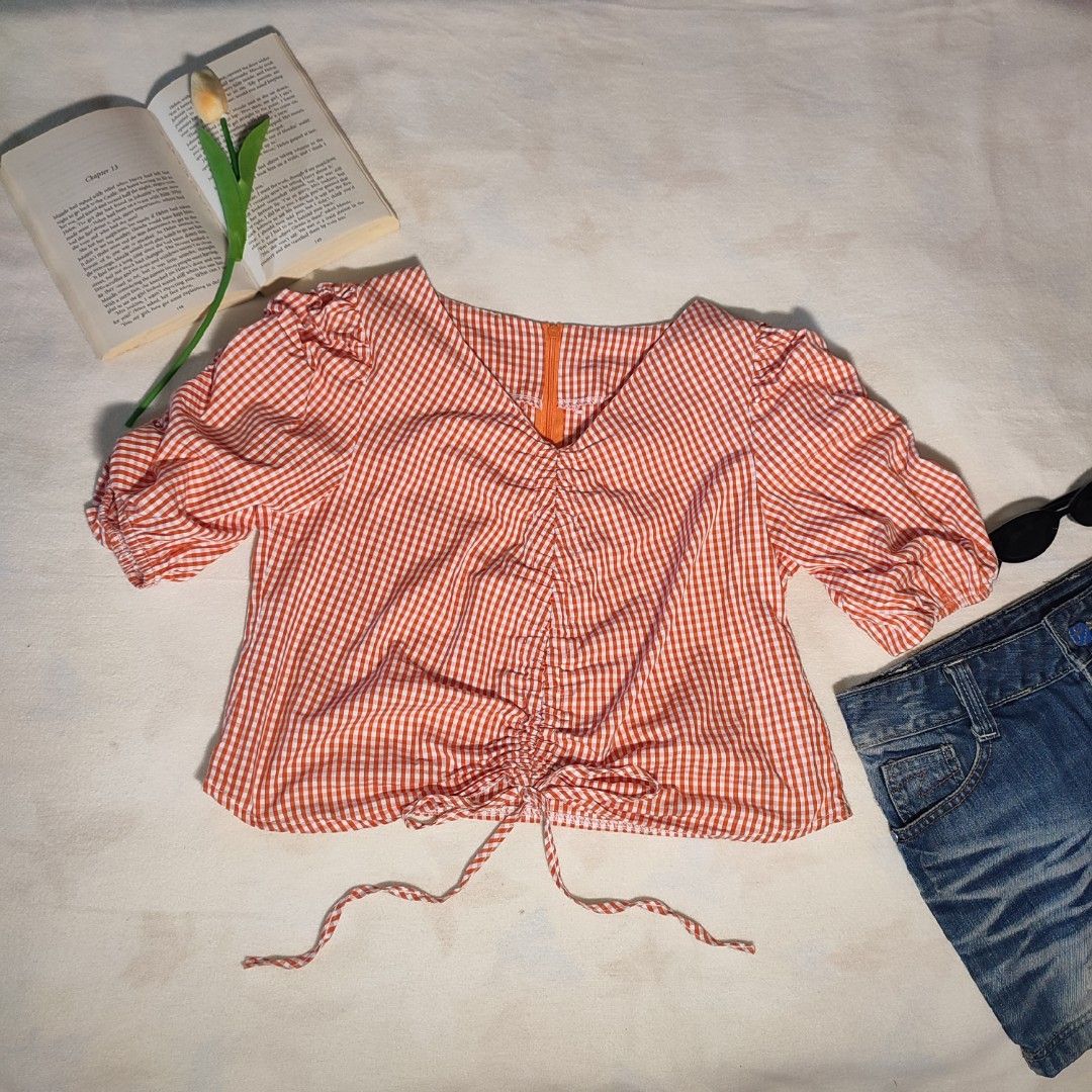 Orange Gingham Ruched Puff Sleeve Top (Category: Blouses) located in Antipolo. Submitted by _lovedbychie (Listing ID 1460044407, Image 1). Description: 🌸 Size: S-Semi M 🌸 Bust: 32" -34" • Length: 17" 🌸 MOP: Gcash / Maribank (payment first) 🌸 MOD: J&T / Lalamove Message me for more info!.