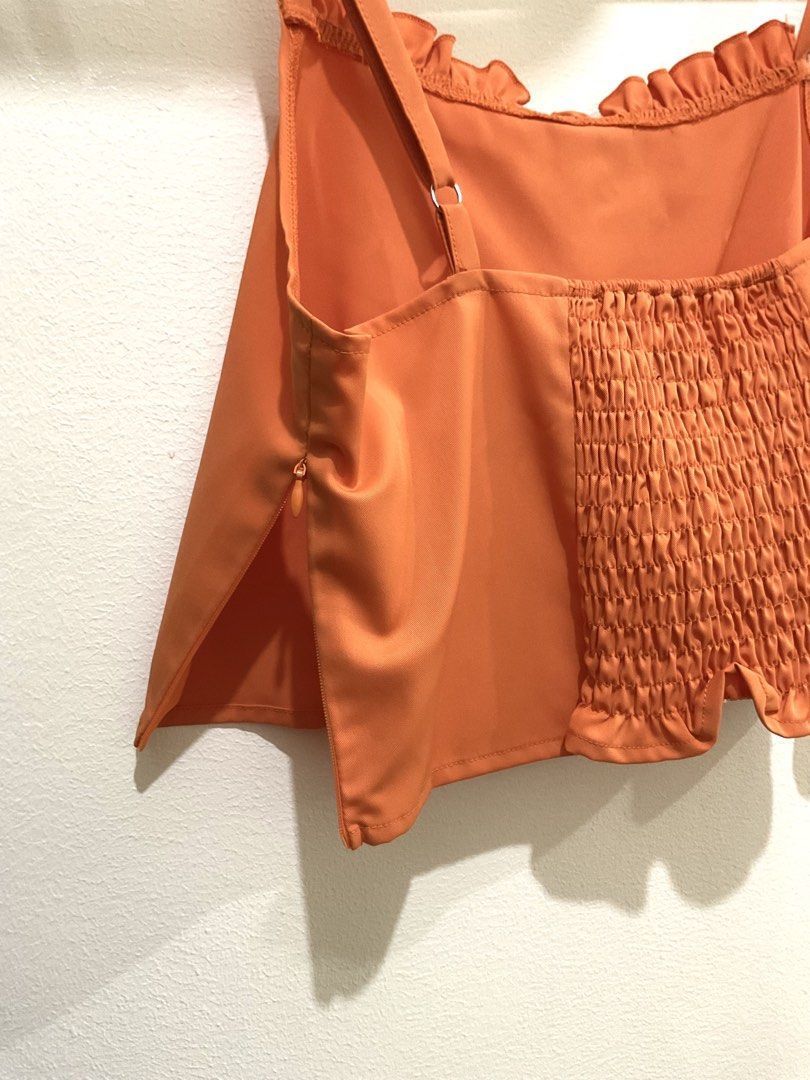Orange Sleeveless Ruffles Top (Category: Sleeveless) located in Manila. Submitted by ilovecheesyramen (Listing ID 1460061879, Image 3). Description: 🪩 used only once! quality is good as neww 🪩 perfect for summer casual fits! 🪩 rfs: decluttering 🪩 size M.