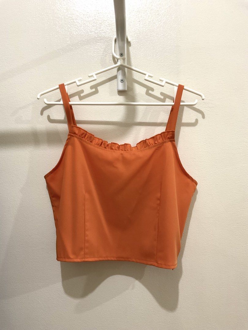 Orange Sleeveless Ruffles Top (Category: Sleeveless) located in Manila. Submitted by ilovecheesyramen (Listing ID 1460061879, Image 1). Description: 🪩 used only once! quality is good as neww 🪩 perfect for summer casual fits! 🪩 rfs: decluttering 🪩 size M.