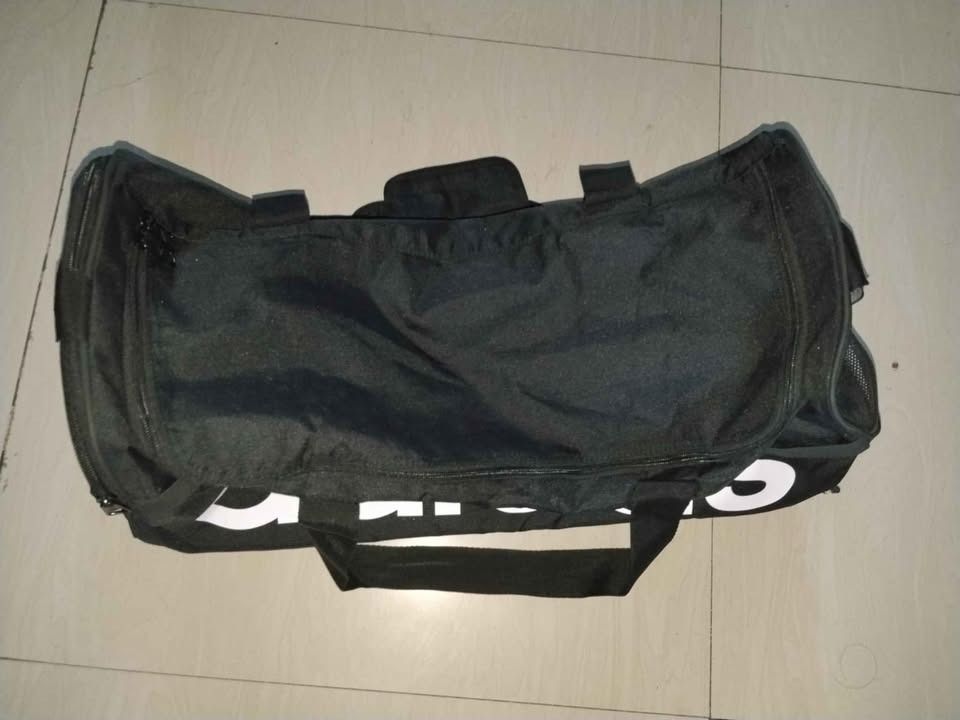 Original Adidas Black Duffel Bag (Category: Backpacks) located in Quezon City. Submitted by shine_my_preloved (Listing ID 1459992162, Image 2). Description: Brand: Adidas Model: Linear Duffel M Size: Medium Dimensions: 22 × 56 × 28 cm Capacity: 39 Litter Color: Black Material: 100% recycled polyester outer/lining Product code: HT4743 - Good Condition - Slight Use - No Damage - Look brand new RFS: Too big for my personal use. No issues with the ba