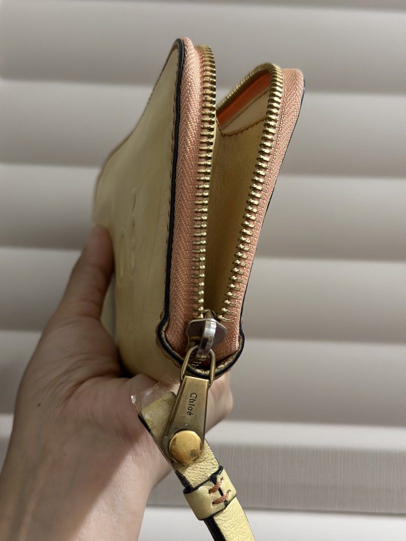 Original Chloe Leather Zip Around Wallet (Category: Wallets & Card holders) located in Naga. Submitted by bag.net (Listing ID 1459963689, Image 3). Description: - Genuine yellow Chloe leather wallet(from Japan 🇯🇵) -Guaranteed original 💯 moneyback if proven fake - Features embossed Chloe logo - Secure zip-around closure - Elegant gold hardware - Multiple interior card slots and compartments - Shows some signs of wear (exterior & interior) - Ide