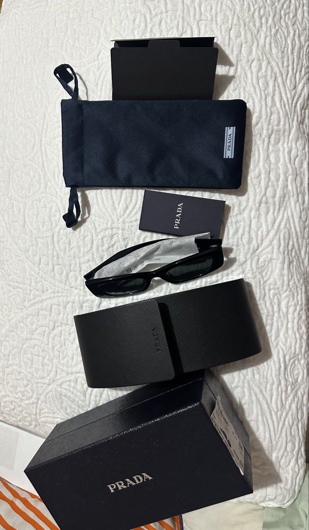 Original Prada OPR03SD Sunglasses - Black (Category: Sunglasses & Eyewear) located in Subic. Submitted by ruffa_assorted_item (Listing ID 1460100951, Image 3). Description: - Authentic Prada Sunglasses - Bought from Dubai - Model: OPR03SD - Frame Color: Black - Lens Color: Dark Grey - Made in Italy - Comes with original box - Please check photos for detailed condition.