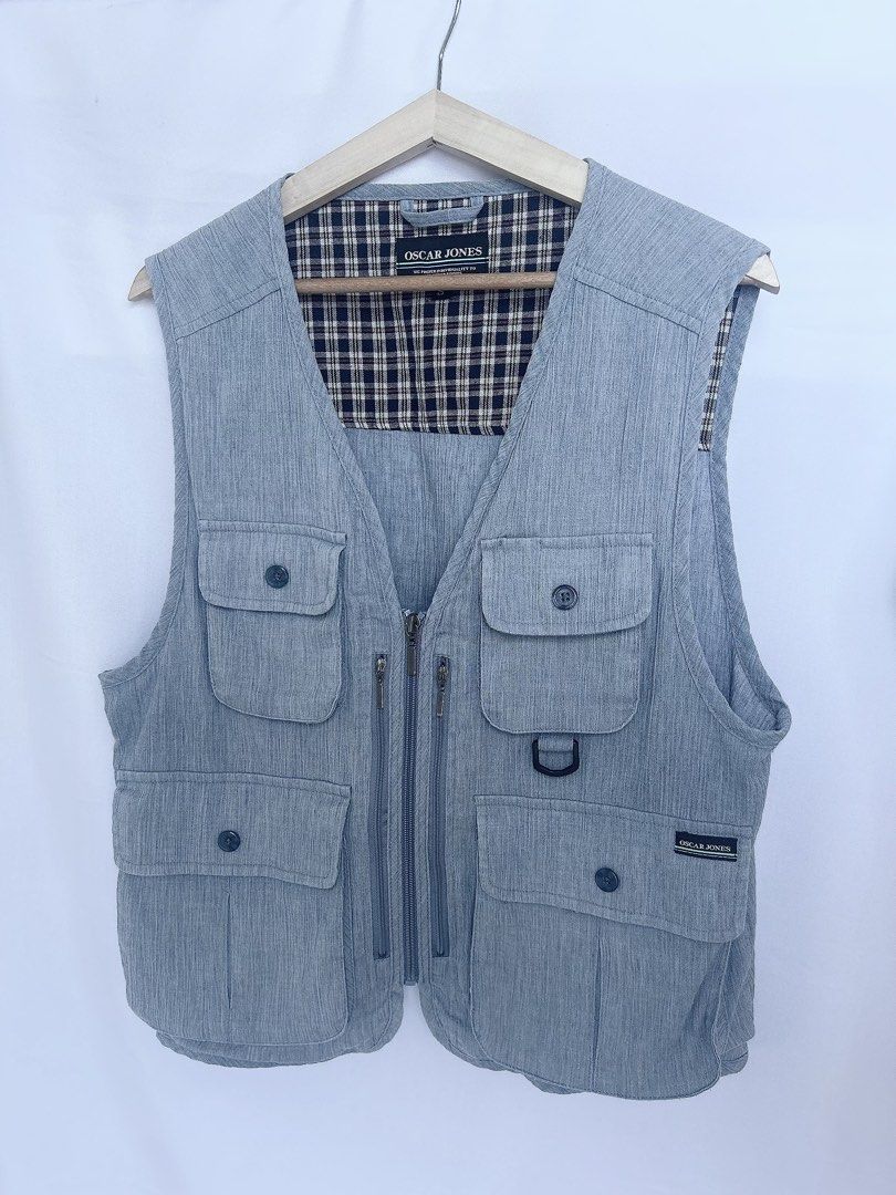 Oscar Jones Light Blue Utility Vest (Category: Vests) located in Manila. Submitted by anjidoll_ (Listing ID 1459984054, Image 2). Description: - Light blue utility vest by Oscar Jones - Multiple pockets with zippers and buttons for ample storage - Lined with a classic plaid pattern - Front zipper closure for easy wear - Perfect for layering over outfits - Versatile for outdoor activities or a casual streetwear aesthetic -can be UNISEX MOP: gcash 