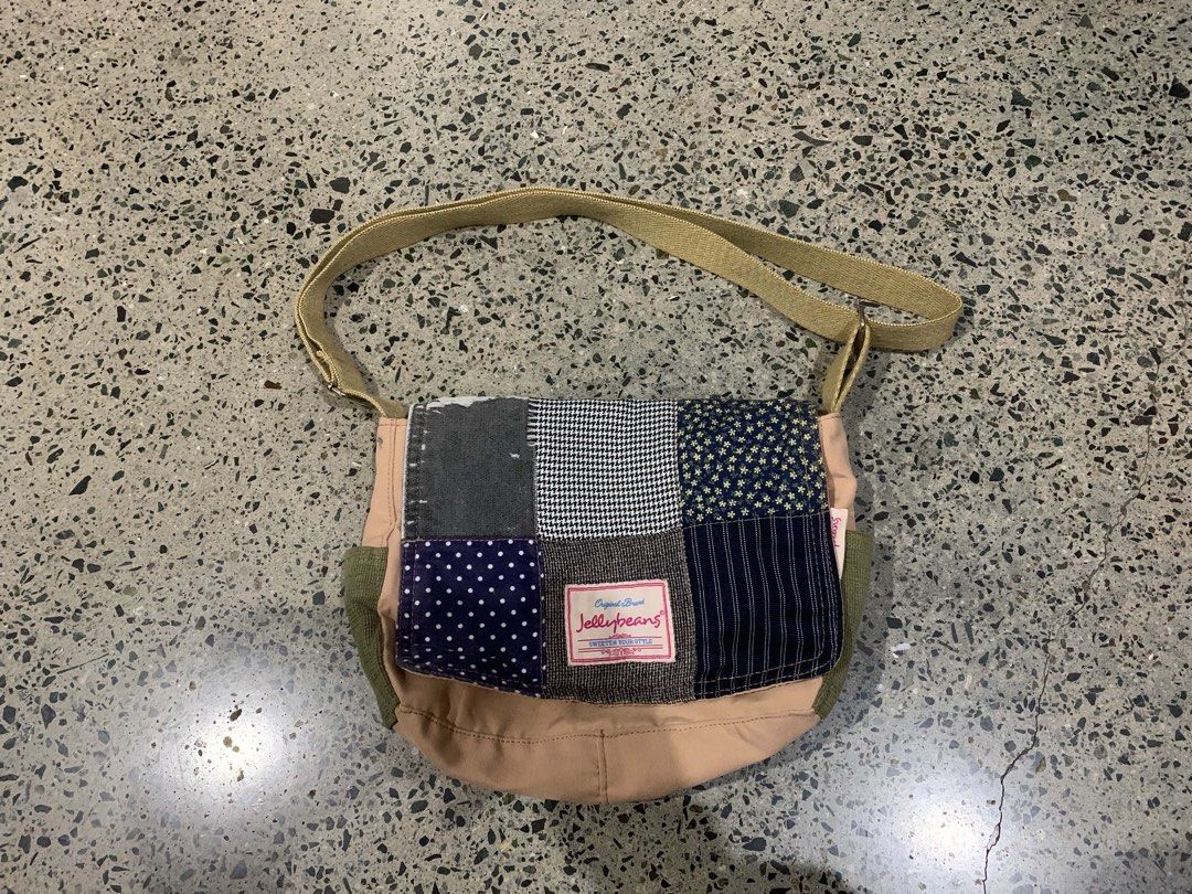 Patchwork Bag (Category: Cross-body Bags) located in Manila. Submitted by everythingwlove (Listing ID 1460079472, Image 1). Description: - Adorable patchwork messenger bag from Jollybeans. - Features a fun mix of polka dots, houndstooth, and star patterns. - Adjustable strap for comfortable wear. - Light pink main body with contrasting green side pockets. - Ideal for everyday use and carrying your essentials..