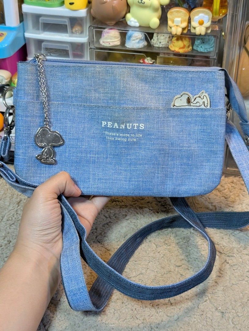 Peanuts Snoopy Sling Bag (Category: Cross-body Bags) located in San Pedro. Submitted by eurisilvers (Listing ID 1460052126, Image 1). Description: slight stain and chipped off logo but has a lot of compartments inside + zippers are still good. — shipping is via J&T Express — mop: gcash, maya, bank transfer — location: san pedro city, laguna.
