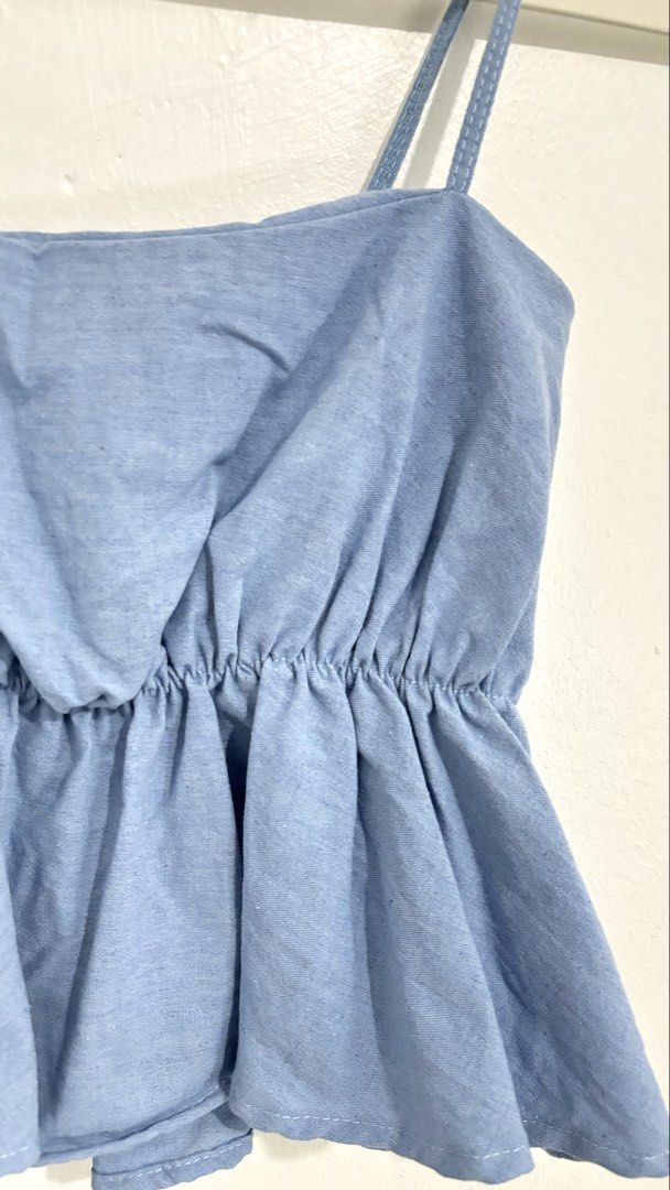 Peplum Cami Top (Category: Sleeveless) located in Caloocan City. Submitted by buymethisandthat (Listing ID 1460031684, Image 2). Description: ✨ Light Blue Elasticized Peplum Cami Top - ₱99 📌 CONDITION • Condition: 8.5/10 • Flaws: None visible 📏 SIZE • Tag Size: No size tag • Recommended: Fits Small to Medium (stretch gathered elastic bust and waist).