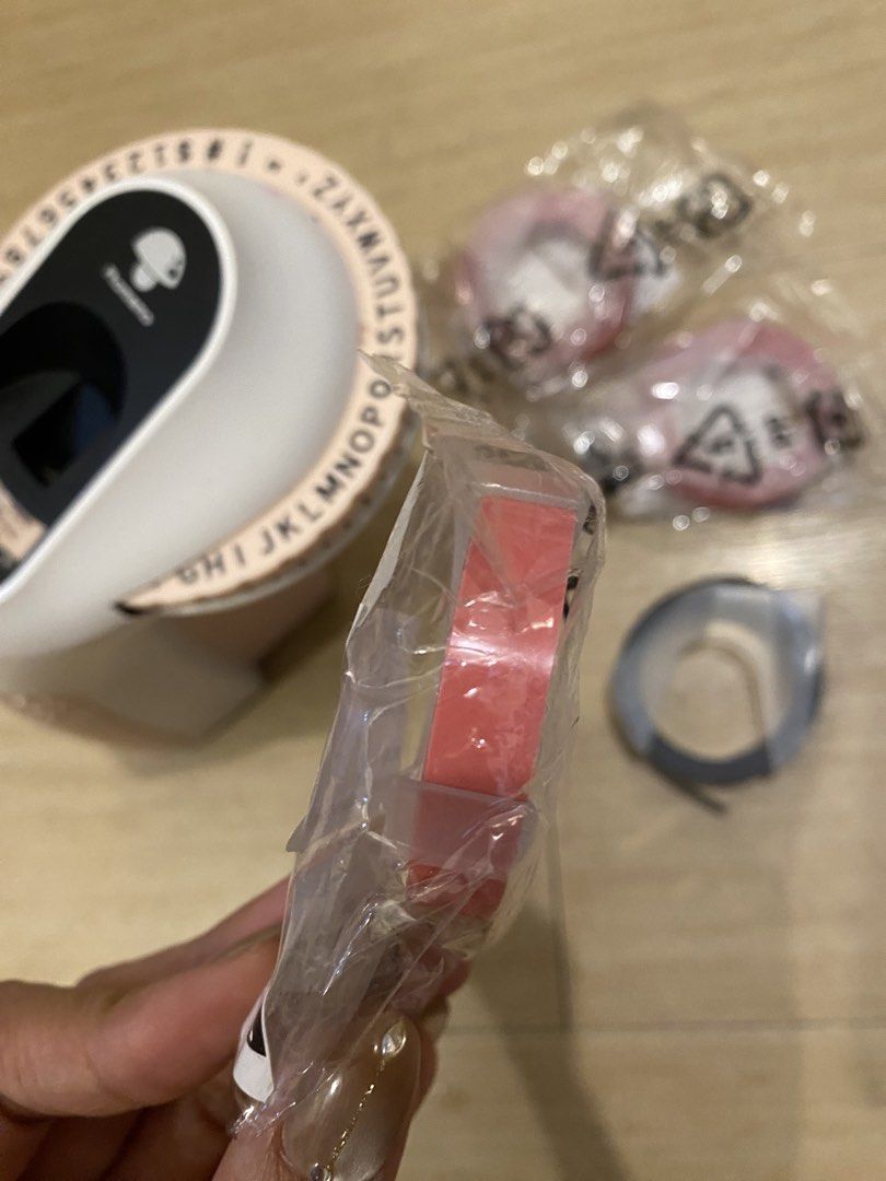 Phomemo E975 Embossing Label Maker Pink with Free Tapes (Category: Craft Supplies & Tools) located in Manila. Submitted by lovendinol14982 (Listing ID 1460031572, Image 2). Description: - Phomemo E975 Embossing Label Maker in Pink - Comes with the label maker unit - Includes multiple tape rolls: pink, black - Ideal for organizing your personal items and belongings - Features an easy-to-use dial for selecting characters.