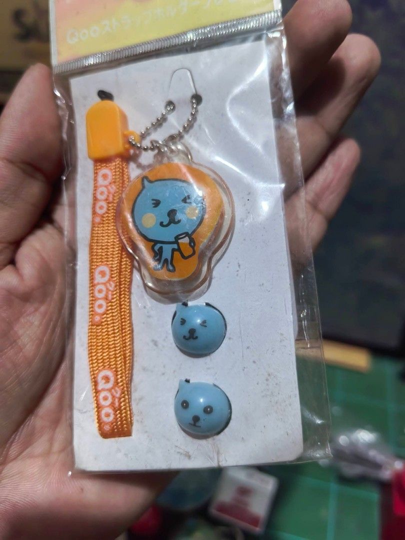 Phone Strap - Coca-Cola Qoo Character Strap and Charm Set. (Category: Other Mobile & Gadget Accessories) located in Cebu City. Submitted by dudes_villanueva (Listing ID 1459933928, Image 2). Description: Phone Strap - Coca-Cola Qoo Character Strap and Charm Set. 📌 Type: Promotional mobile phone strap and accessory holder. 📌 Character: Qoo, the blue mascot from the popular juice drink. 📌 Included Pieces: An orange fabric strap, a main Qoo chara