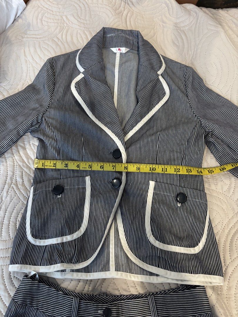 Pinstripe Blazer and Flare Pants Set (Category: Sets or Coordinates) located in Cabuyao City. Submitted by thriftedwonders18 (Listing ID 1460006324, Image 2). Description: - Classic pinstripe blazer and flare pants set - Blazer: White trim, two-button closure - Pants: High-waisted, double button closure - Perfect for professional or casual outfits - Detailed measurements for blazer and pants included in photos.