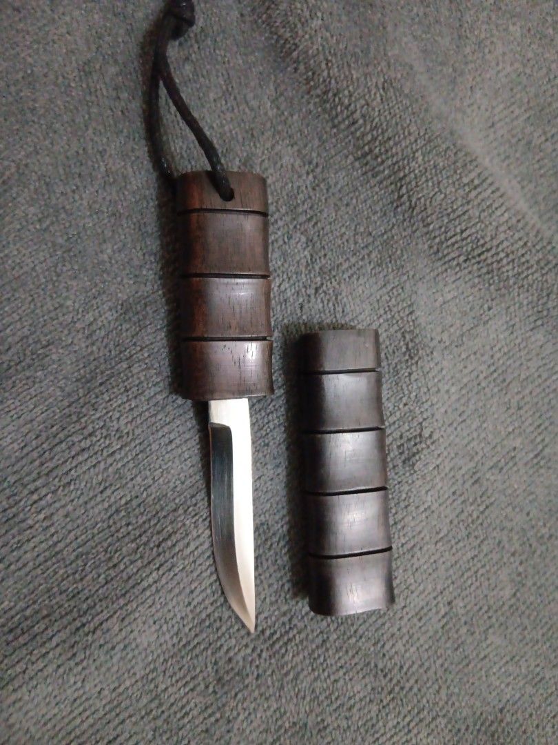 Pocket Knife (Category: Knives & Chopping Boards) located in Manila. Submitted by ocyobe4man (Listing ID 1460048398, Image 1). Description: - Pocket knife with a distinctive wooden handle and matching sheath. - Features a sharp, polished blade. - Crafted with a natural wood finish for a unique look. - Compact and designed for everyday carry. - Includes a protective wooden sheath..