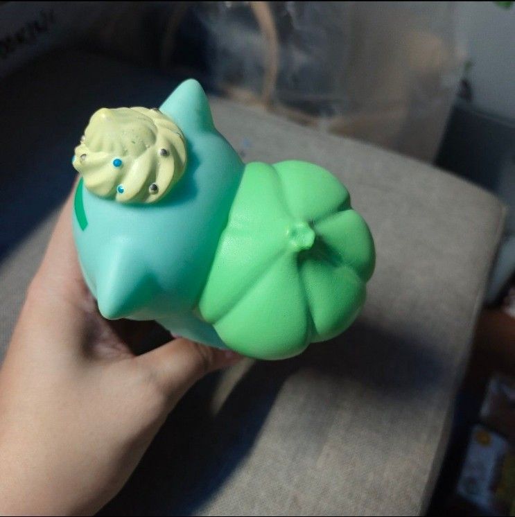 Pokemon Bulbasaur Ice Cream Figurine Toy (Category: Designer & Blind Box Toys) located in Quezon City. Submitted by dncpreloved (Listing ID 1459968995, Image 3). Description: - Adorable Bulbasaur shaped like an ice cream cone. - Features a light blue body with a green ice cream top. - Decorated with sprinkles on the ice cream and Bulbasaur's head. - Makes a charming desk decoration..