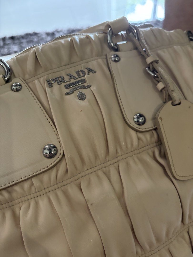 Prada Beige Nappa Gaufre Satchel (Category: Luxury Bags & Wallets) located in Antipolo. Submitted by pinkktopaz (Listing ID 1459984864, Image 3). Description: Well used with minor signs of usage Bought in the US W/ authenticity card Minor stains/discoloration Slight discoloration on the long strap but not noticeable Slightly negotiable.