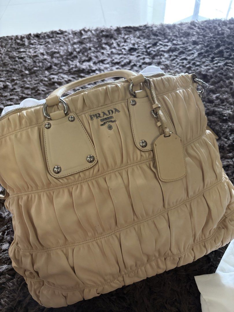 Prada Beige Nappa Gaufre Satchel (Category: Luxury Bags & Wallets) located in Antipolo. Submitted by pinkktopaz (Listing ID 1459984864, Image 1). Description: Well used with minor signs of usage Bought in the US W/ authenticity card Minor stains/discoloration Slight discoloration on the long strap but not noticeable Slightly negotiable.