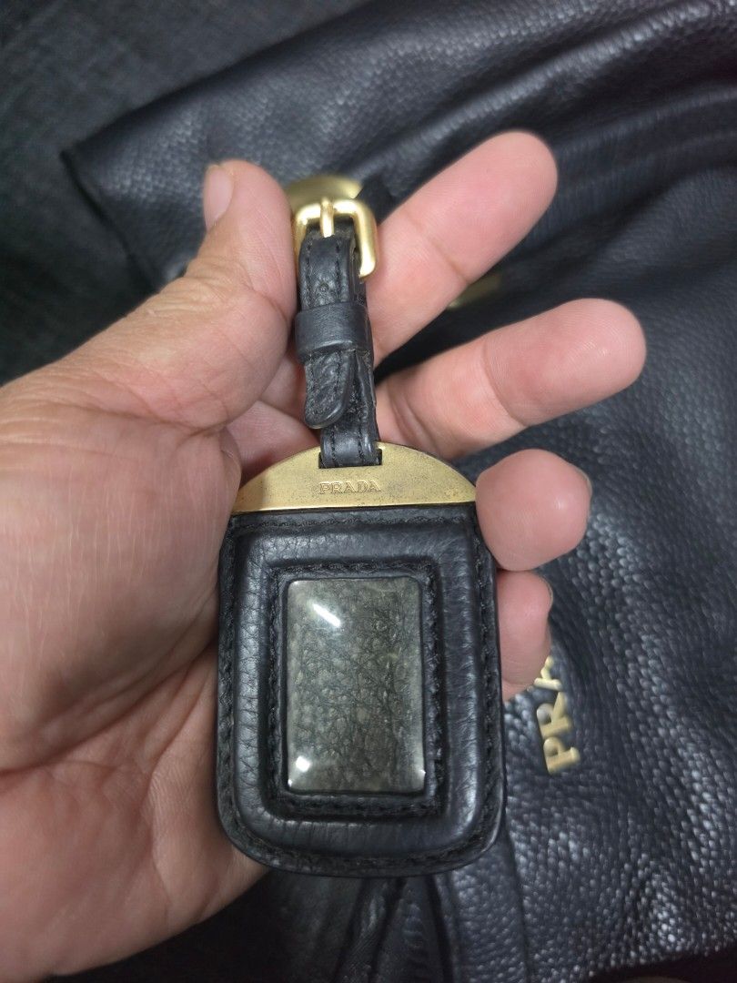 Prada Black Leather Tote Bag with Gold Hardware (Category: Shoulder Bags) located in General Trias. Submitted by roselle2230 (Listing ID 1460038467, Image 3). Description: - Prada tote bag - Material: Black pebbled leather - Hardware: Gold-tone - Features: Double top handles, interior zip pocket, branded tag, leather key tag - Condition: Great for everyday use.
