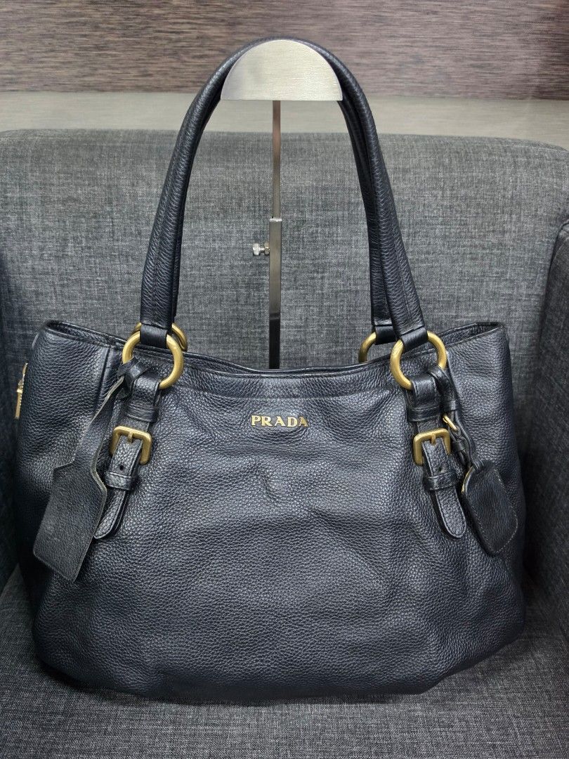 Prada Black Leather Tote Bag with Gold Hardware (Category: Shoulder Bags) located in General Trias. Submitted by roselle2230 (Listing ID 1460038467, Image 1). Description: - Prada tote bag - Material: Black pebbled leather - Hardware: Gold-tone - Features: Double top handles, interior zip pocket, branded tag, leather key tag - Condition: Great for everyday use.