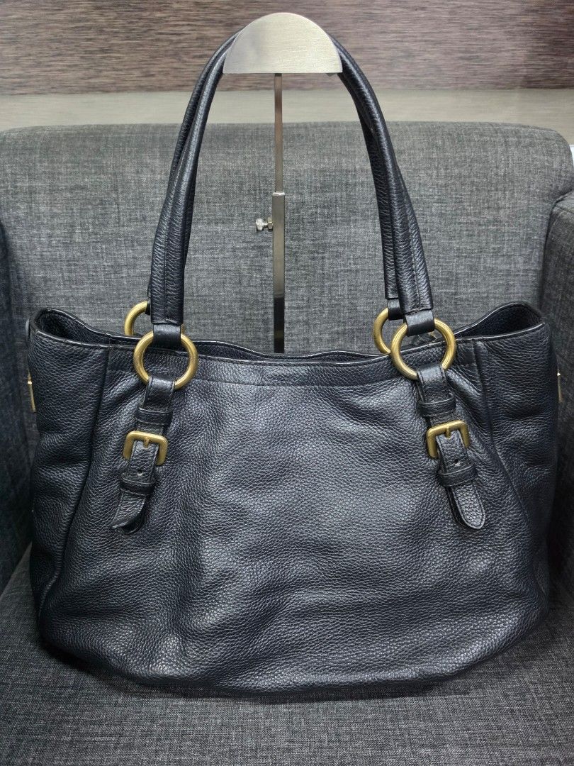 Prada Black Leather Tote Bag with Gold Hardware (Category: Shoulder Bags) located in General Trias. Submitted by roselle2230 (Listing ID 1460038467, Image 2). Description: - Prada tote bag - Material: Black pebbled leather - Hardware: Gold-tone - Features: Double top handles, interior zip pocket, branded tag, leather key tag - Condition: Great for everyday use.