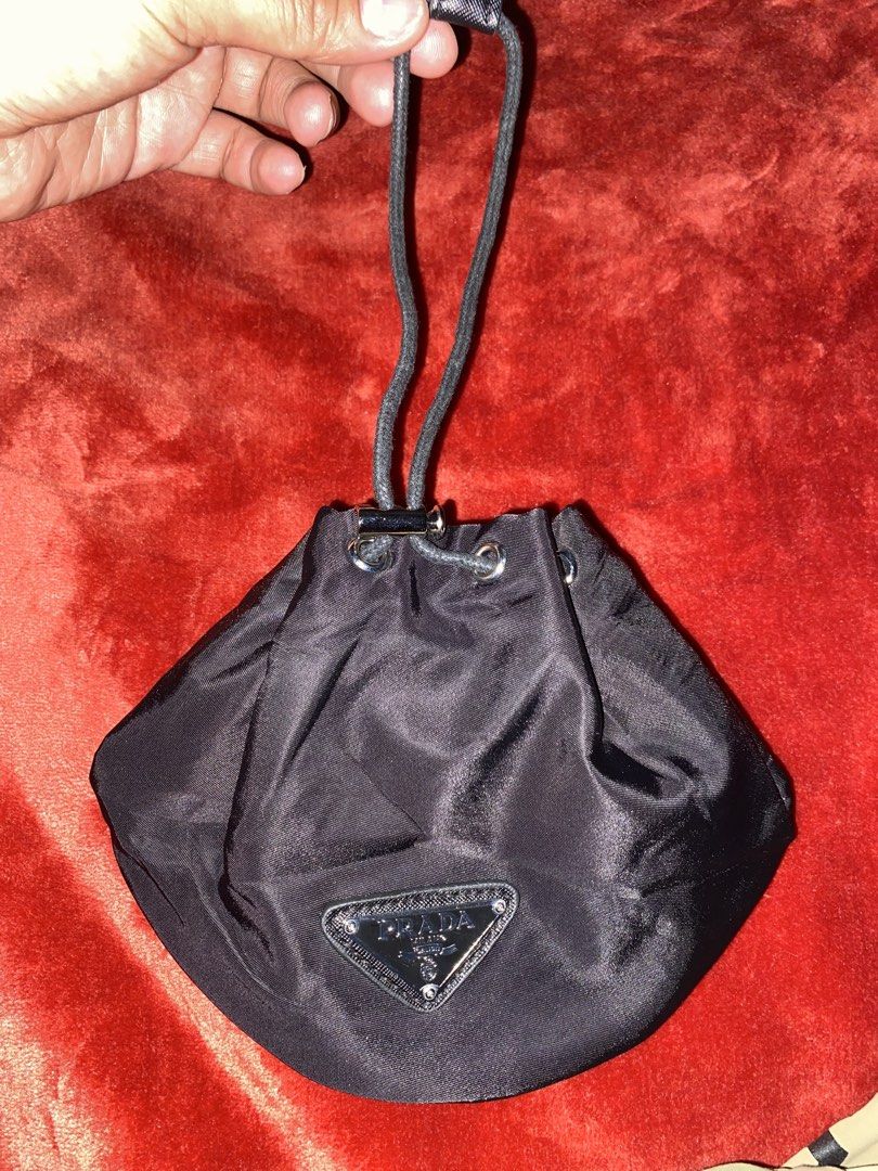 Prada Black Nylon Drawstring Pouch Bag (Category: Luxury Bags & Wallets) located in Alburquerque. Submitted by zanegavynn43872 (Listing ID 1459943269, Image 2). Description: - Authentic not guaranteePrada pouch - Black nylon material - Drawstring closure - Iconic Prada triangle logo - Ideal for organizing small essentials or as a makeup bag - Compact and lightweight.