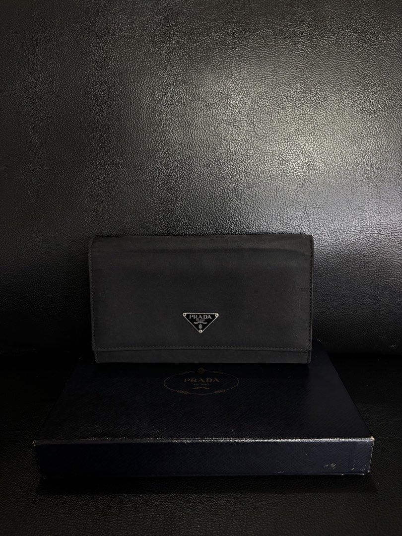 Prada Black Nylon Wallet with Box (Category: Luxury Bags & Wallets) located in Manila. Submitted by chantalsalonga (Listing ID 1460090736, Image 1). Description: - Authentic Prada wallet - Black nylon material - Multiple card slots for organization - Interior zippered compartment - Comes with original Prada box - Ideal for keeping essentials tidy.