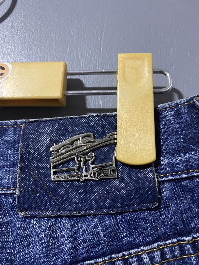 PRADA Milano Denim Jeans (Category: Jeans) located in Tanay. Submitted by judevalcorza (Listing ID 1460098449, Image 3). Description: - PRADA blue wash denim jeans - Size 32/33 Length 39 Leg Opening 7 - Classic straight leg fit - Distressed detailing on front and back pockets - Silver hardware with PRADA branding - Versatile staple piece for any wardrobe - Very Good Used Condition - 1500 Plus Ship.