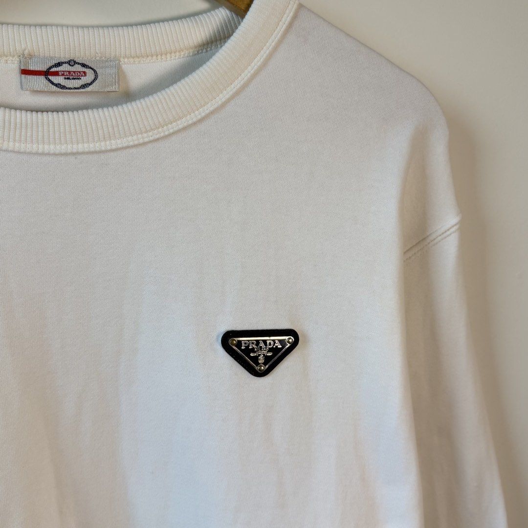 Prada Signature Chest Logo White Sweater (Category: Coats, Jackets and Outerwear) located in Paniqui. Submitted by justyntrouves (Listing ID 1459937176, Image 3). Description: Tag Size: Large (Dimensions in inches) Width: 24 Length: 28 Condition: 9/10 Buyer will shoulder the shipping fee. Check all photos before purchasing. For any questions, feel free to ask. .