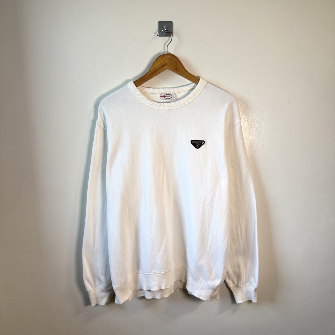 Prada Signature Chest Logo White Sweater (Category: Coats, Jackets and Outerwear) located in Paniqui. Submitted by justyntrouves (Listing ID 1459937176, Image 1). Description: Tag Size: Large (Dimensions in inches) Width: 24 Length: 28 Condition: 9/10 Buyer will shoulder the shipping fee. Check all photos before purchasing. For any questions, feel free to ask. .
