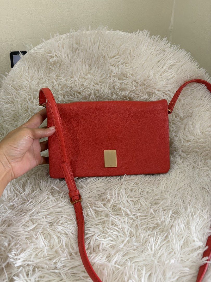 Preloved Couronne Crossbody Bag (Category: Cross-body Bags) located in General Mariano Alvarez. Submitted by maxiscollections (Listing ID 1460047411, Image 1). Description: Preloved Couronne Crossbody Bag Red orange color Like new .