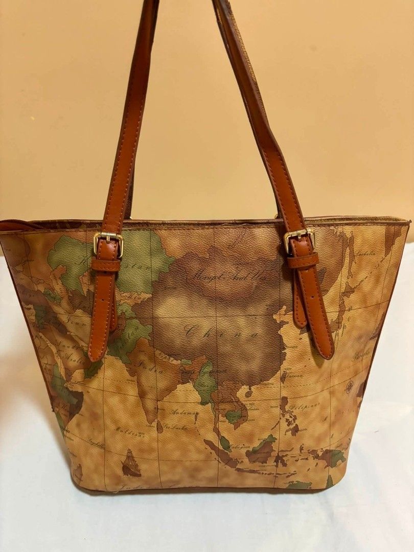Prima Classe Geo Map Tote Bag (Category: Tote Bags) located in Manila. Submitted by lhen666 (Listing ID 1460029338, Image 2). Description: - Classic Prima Classe tote bag - Signature geo map print - Genuine leather trim and handles - Interior zip pocket - Gold tone hardware - Spacious interior for essentials - Ideal for travel or everyday use.