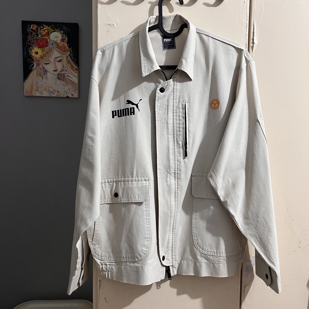 Puma Jacket L Beige Zip Up Utility Style (Category: Coats, Jackets and Outerwear) located in Makati City. Submitted by mikatamayo (Listing ID 1459939146, Image 1). Description: - Beige Puma Jacket - Size: Large (L) - Zip-up front closure - Multiple pockets for storage - Features a zippered chest pocket - Small, distinctive orange circular logo on the right chest - Made in Vietnam - Ideal for casual outfits or as a layering piece.