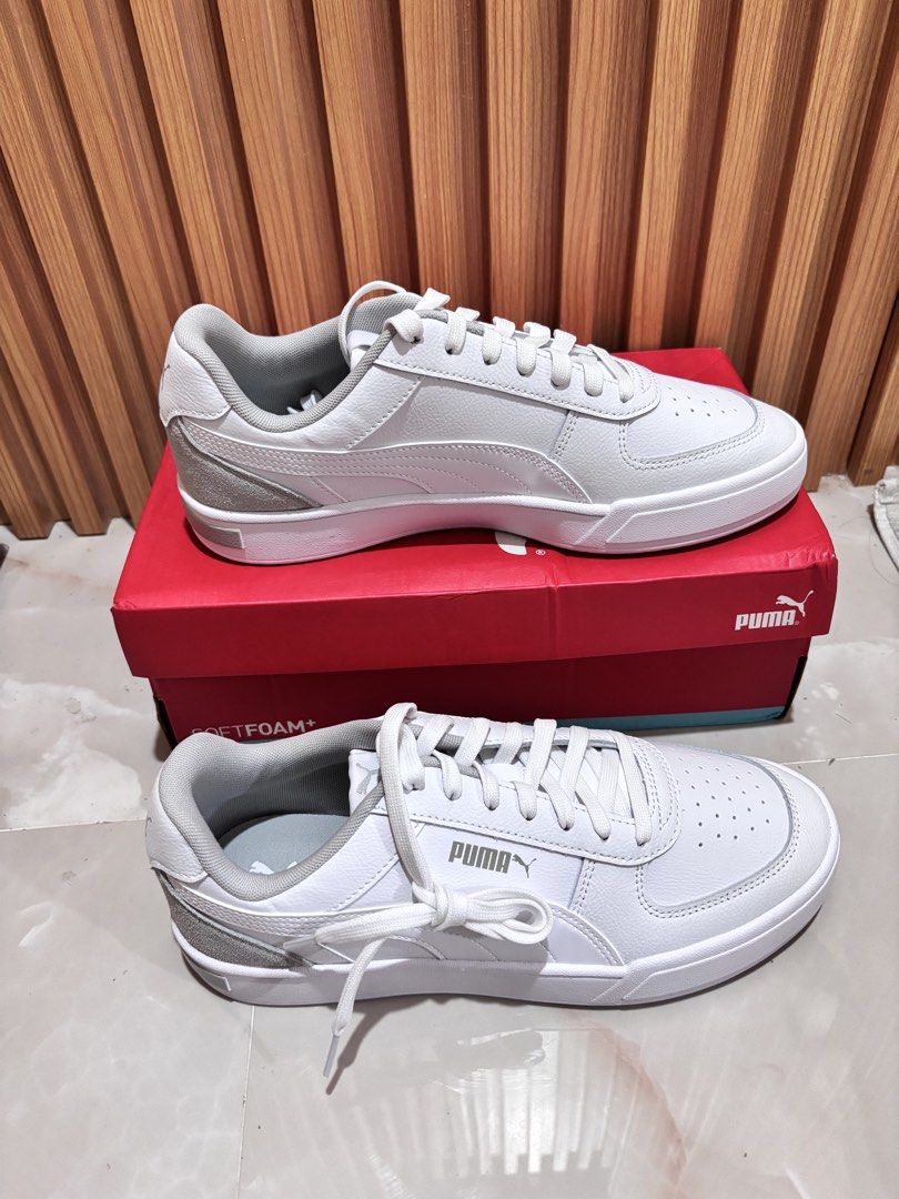 Puma White Sneakers with Grey Accents (Category: Sneakers) located in General Trias. Submitted by kibuloid (Listing ID 1460076771, Image 2). Description: - Brand New -Size 9.5 -Classic white Puma sneakers - Grey suede accents on heel and side - Lace-up closure - Puma branding on the sole - Includes original red Puma box - Ideal for everyday casual wear.