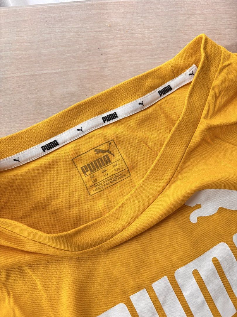 Puma Yellow T-shirt with Logo (Category: Tshirts & Polo Shirts ) located in Manila. Submitted by mitzdcstr6 (Listing ID 1459979820, Image 2). Description: - Vibrant yellow Puma t-shirt - Features the classic Puma logo prominently on the front - Stylish Puma stripe detail runs down the back - Comfortable and casual design - Ideal for everyday wear and a relaxed look.