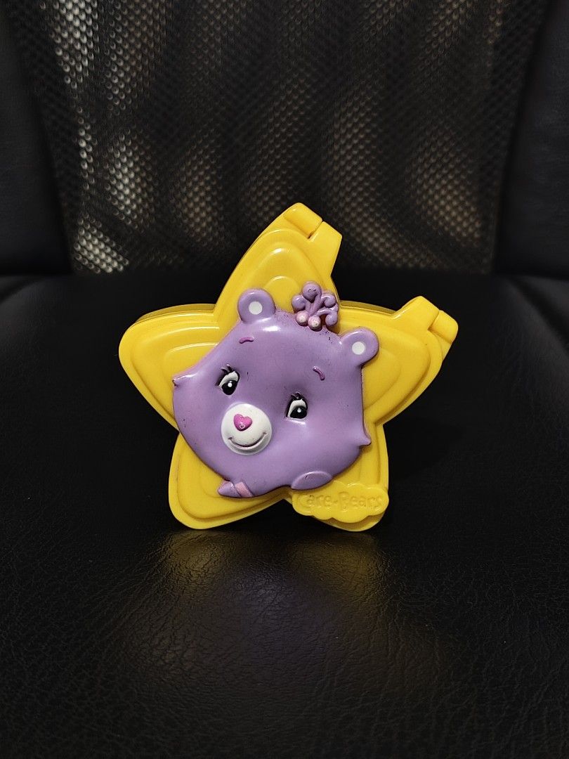 purple Care Bears Harmony Bear star-shaped folding compact mirror (Category: Character Goods) located in Bulacan. Submitted by angel.decluttersx (Listing ID 1460081525, Image 1). Description: Jollibee 2000s needs cleaning inside.