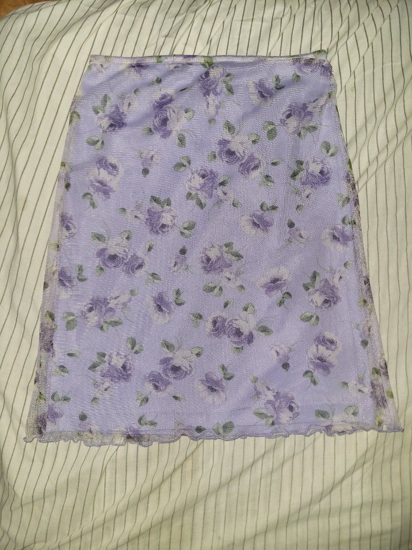 Purple Floral Mesh Skirt (Category: Others Tops) located in Mangaldan. Submitted by cha_reyna (Listing ID 1459997760, Image 1). Description: - Adorable purple skirt - Features a charming floral print - Trendy lettuce hem edges - Made with stretchy material for a comfortable fit - Offers a fun and flirty vibe.