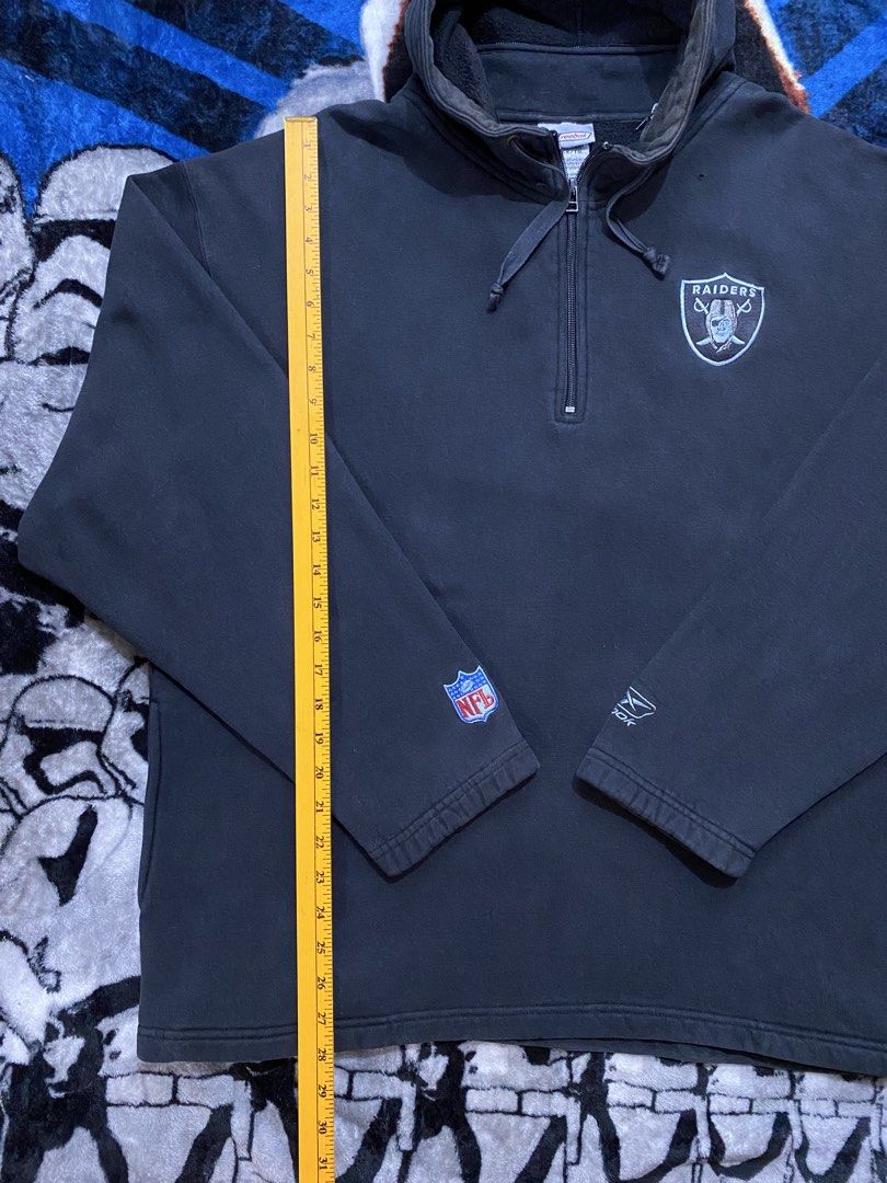 Raiders quarter-zip hooded sweatshirt (Category: Hoodies) located in Cavite. Submitted by jc_thrift95 (Listing ID 1460077498, Image 2). Description: - This is a black Las Vegas Raiders quarter-zip hooded sweatshirt featuring the team’s classic shield logo on the left chest. - a genuine, officially licensed vintage Reebok NFL piece likely produced during Reebok’s exclusive NFL apparel partnership. - Two side pockets. - Color rate 8/10 ( Faded,pin 